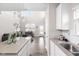 Modern kitchen flows into the living area, boasting white cabinets and contemporary finishes at 2892 Maricopa Blvd, Whitestown, IN 46075