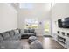 Bright living room showcasing a gray sectional sofa, tall ceilings, and a large window at 2892 Maricopa Blvd, Whitestown, IN 46075