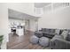 Open-concept living room adjacent to a kitchen with a gray sectional sofa at 2892 Maricopa Blvd, Whitestown, IN 46075
