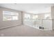 Spacious loft with neutral walls and carpet and a white railing overlooking the first floor at 2892 Maricopa Blvd, Whitestown, IN 46075