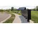 Community mailboxes along the sidewalk with a pond and gazebo in the background at 2892 Maricopa Blvd, Whitestown, IN 46075