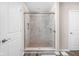Modern shower with a glass door and tiled walls with decorative accents at 2892 Maricopa Blvd, Whitestown, IN 46075