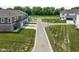 A street view of modern townhomes featuring attached garages and a well-maintained green landscape at 2892 Maricopa Blvd, Whitestown, IN 46075
