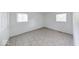 Bedroom featuring tile flooring and natural light from two windows at 3817 Strathmore Dr, Indianapolis, IN 46235