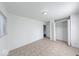 A bright bedroom featuring neutral colors, closet with paneled doors, and light ceramic tile flooring at 3817 Strathmore Dr, Indianapolis, IN 46235