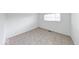 A bedroom space featuring neutral colors, window, and light ceramic tile flooring at 3817 Strathmore Dr, Indianapolis, IN 46235
