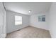 A bright bedroom featuring neutral colors, windows, and light ceramic tile flooring at 3817 Strathmore Dr, Indianapolis, IN 46235
