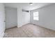 A bright bedroom featuring neutral colors, closet with paneled doors, and light ceramic tile flooring at 3817 Strathmore Dr, Indianapolis, IN 46235
