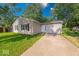 A cozy one-story home featuring a well-manicured lawn and concrete driveway at 3817 Strathmore Dr, Indianapolis, IN 46235