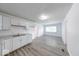 Modern kitchen featuring white cabinets and stainless steel sink, seamlessly connected to the living area at 3817 Strathmore Dr, Indianapolis, IN 46235