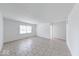 Bright living room featuring tile floors and ample natural light from the large window at 3817 Strathmore Dr, Indianapolis, IN 46235