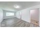 Bright living room featuring gray wood-look flooring and a window for natural light at 3817 Strathmore Dr, Indianapolis, IN 46235
