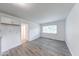 Bright living room featuring gray wood-look flooring and a window for natural light at 3817 Strathmore Dr, Indianapolis, IN 46235