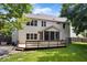 Rear view of house with deck, screened in porch, and fenced yard at 3823 Vanguard Cir, Carmel, IN 46032