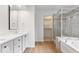 Updated bathroom featuring double sinks, soaking tub, glass enclosed shower, and modern finishes at 3823 Vanguard Cir, Carmel, IN 46032