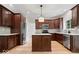 Spacious kitchen features stainless steel appliances, granite countertops, and dark wood cabinets at 3823 Vanguard Cir, Carmel, IN 46032