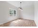 Bright and spacious room with hardwood floors, a large window, and modern light fixture at 3823 Vanguard Cir, Carmel, IN 46032