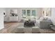 Bright, staged living room with hardwood floors, stylish decor, and a large window for natural light at 3823 Vanguard Cir, Carmel, IN 46032
