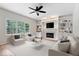 Cozy living room featuring fireplace, built-in bookshelves, neutral decor, and plush seating at 3823 Vanguard Cir, Carmel, IN 46032
