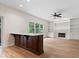 Bright living room with hardwood floors, fireplace, ceiling fan, and built-in shelves at 3823 Vanguard Cir, Carmel, IN 46032