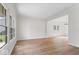 Bright and airy living room with hardwood floors, large windows, and neutral paint color scheme at 3823 Vanguard Cir, Carmel, IN 46032