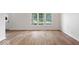 Spacious living room showcasing beautiful hardwood floors and a large window for ample natural light at 3823 Vanguard Cir, Carmel, IN 46032