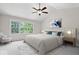 Comfortable bedroom with vaulted ceiling, large window, and neutral decor at 3823 Vanguard Cir, Carmel, IN 46032