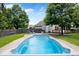 Backyard oasis features a large inground swimming pool surrounded by lush green grass at 3823 Vanguard Cir, Carmel, IN 46032