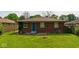 A view of the backyard of the house showing the lawn, the back of the house, and the surrounding properties at 3922 N Irvington Ave, Indianapolis, IN 46226