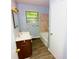 Bright bathroom features a ceramic tile shower and neutral paint and updated flooring at 3922 N Irvington Ave, Indianapolis, IN 46226