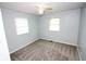This carpeted bedroom is bright with two windows and a ceiling fan at 3922 N Irvington Ave, Indianapolis, IN 46226