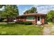 Charming single-story red brick home with a well-manicured lawn and lovely front yard landscaping at 3922 N Irvington Ave, Indianapolis, IN 46226