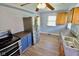 The kitchen features a stainless steel refrigerator, updated flooring and custom cabinets at 3922 N Irvington Ave, Indianapolis, IN 46226