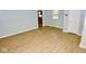 Bright living room with wood-look flooring and fresh paint is adjacent to the kitchen at 3922 N Irvington Ave, Indianapolis, IN 46226