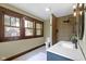 Modern bathroom with vanity, wood wall and multiple windows at 4002 Guilford Ave, Indianapolis, IN 46205