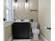 A charming bathroom features a sleek black vanity, modern lighting, and a toilet at 4002 Guilford Ave, Indianapolis, IN 46205
