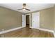 Neutral bedroom with ceiling fan and open door to another room at 4002 Guilford Ave, Indianapolis, IN 46205