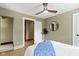 Stylish bedroom with hardwood floors, a round mirror, and a plant at 4002 Guilford Ave, Indianapolis, IN 46205