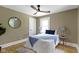 Stylish bedroom with hardwood floors, a round mirror, and a window at 4002 Guilford Ave, Indianapolis, IN 46205