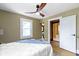 Bedroom with hardwood floors and open door to bathroom with shower at 4002 Guilford Ave, Indianapolis, IN 46205