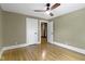 Neutral bedroom with hardwood floors and ceiling fan at 4002 Guilford Ave, Indianapolis, IN 46205