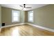 Cozy bedroom with hardwood floors and two windows at 4002 Guilford Ave, Indianapolis, IN 46205