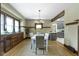 Bright dining room has a white table set, wooden trim, and an open view of the modern kitchen at 4002 Guilford Ave, Indianapolis, IN 46205