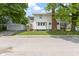 Charming two-story home with a detached garage and a well-maintained lawn at 4002 Guilford Ave, Indianapolis, IN 46205