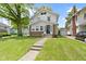 Charming two-story home featuring a well-manicured lawn, inviting front porch, and a classic facade at 4002 Guilford Ave, Indianapolis, IN 46205