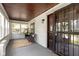 Inviting front porch with a seating area, wood ceilings, large windows, and a secure front door at 4002 Guilford Ave, Indianapolis, IN 46205
