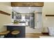 Open kitchen design with gray cabinets, white countertops, stainless appliances, and breakfast bar at 4002 Guilford Ave, Indianapolis, IN 46205