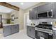 Gray cabinets with a view into a dining room give the kitchen a spacious feel at 4002 Guilford Ave, Indianapolis, IN 46205