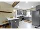 Modern kitchen featuring gray cabinetry, stainless steel appliances, and a center island with seating at 4002 Guilford Ave, Indianapolis, IN 46205