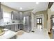 Modern kitchen with gray cabinets and stainless steel appliances adjacent to dining area at 4002 Guilford Ave, Indianapolis, IN 46205